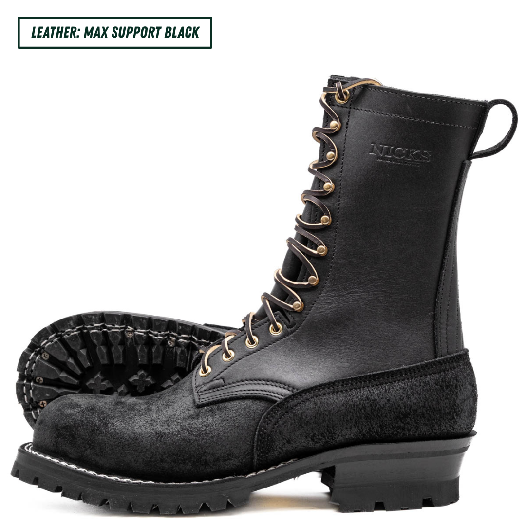 A pair of black leather lace-up work boots with gold-tone eyelets and a rugged lug sole, shown on a white background with a text label reading 'LEATHER: MAX SUPPORT BLACK'.