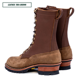 A pair of lace-up work boots in brown leather and suede, shown from a side profile view on a white background. A text label in the top-left corner reads 'LEATHER: 1964 BROWN'.