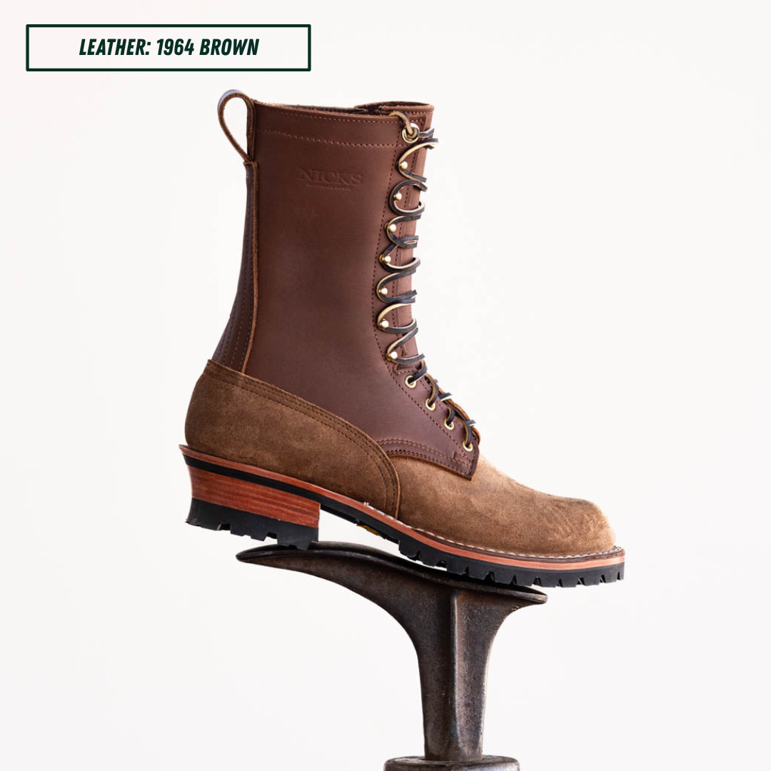 A 12-inch lace-up work boot in dark brown leather and tan suede, displayed on a metal anvil against a white background. A text label in the top-left corner reads 'LEATHER: 1964 BROWN'.