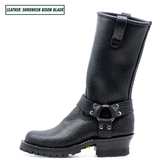 A single mid-calf black leather boot with a pebbled texture, a buckle strap detail on the side, and a chunky lug sole, shown against a plain white background with a text label in the top-left corner.