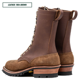 A pair of brown leather lace-up boots shown on a white background, with a text label in the top-left corner reading 'LEATHER: 1964 BROWN'. The boots feature a dark brown leather shaft, a lighter brown suede toe and heel, and a stacked wood-look midsole with a black outsole.