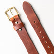 Heavy-duty brown leather work belt with a brass buckle and Nicks Handmade Belts embossed on the strap