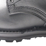 Close-up of a black leather boot showing the side panel, stitching, metal eyelet, and rugged black rubber sole against a white background.