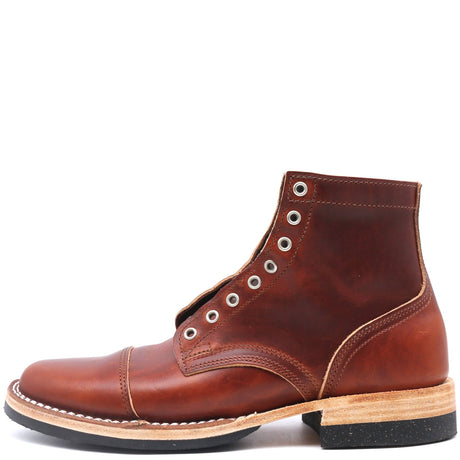 A brown leather lace-up ankle boot with silver metal eyelets, a cap toe, and a stacked wood-and-leather heel, shown from a side profile on a white background.