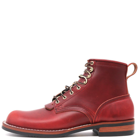 A single red leather lace-up ankle boot with gold-toned metal eyelets, white contrast stitching, and a stacked brown and black sole, shown from a side profile on a white background.