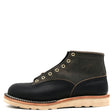 Grey and dark navy blue leather boot with brass hardware and a white wedge outsole in front of a white background.