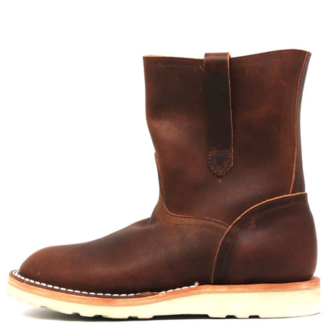 A dark brown leather ankle boot with a pull strap on the side, shown in profile against a white background.