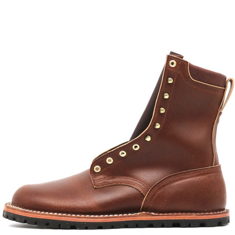 A brown leather lace-up ankle boot with gold-tone metal eyelets and a black lug sole, shown from a side profile on a white background.