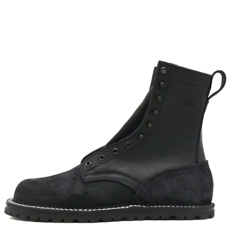 A black leather and suede lace-up ankle boot with metal eyelets, white contrast stitching along the sole, and a pull tab at the heel, shown from a side profile on a white background.