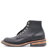 A single black leather lace-up ankle boot with brass eyelets, a stacked wood-look midsole, and a black rubber outsole, shown from a side profile on a white background.