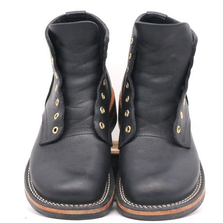 A pair of black leather lace-up ankle boots with gold-tone metal eyelets and white contrast stitching on the soles, shown against a plain white background.