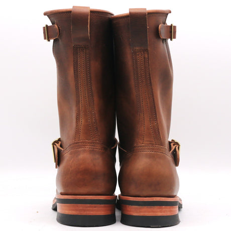 A pair of brown leather riding boots shown from the back, featuring pull straps, buckle details, and stacked soles on a white background.
