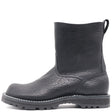 A single black leather ankle boot with a textured, pebbled finish, elastic side gore, and a rugged lug sole, shown from a side profile on a white background.