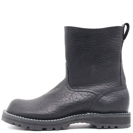 A single black leather ankle boot with a textured, pebbled finish, elastic side gore, and a rugged lug sole, shown from a side profile on a white background.