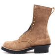 A brown suede mid-calf boot with gold-tone metal eyelets and studs, a black lug sole, and a pull loop on the heel, shown against a plain white background.