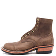 A brown leather lace-up ankle boot with brass eyelets, a low stacked heel, and contrast stitching, shown from a side profile on a white background.