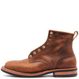 A single brown leather lace-up ankle boot with brass eyelets, a pull tab, and a stacked black and tan sole, shown from a side profile on a white background.