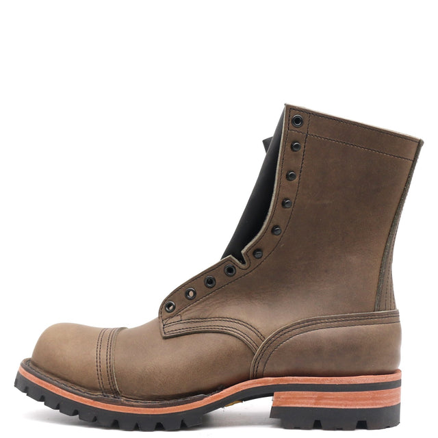 A single brown leather lace-up work boot with a rugged black sole and a contrasting orange-brown midsole layer, shown from a side profile on a white background.