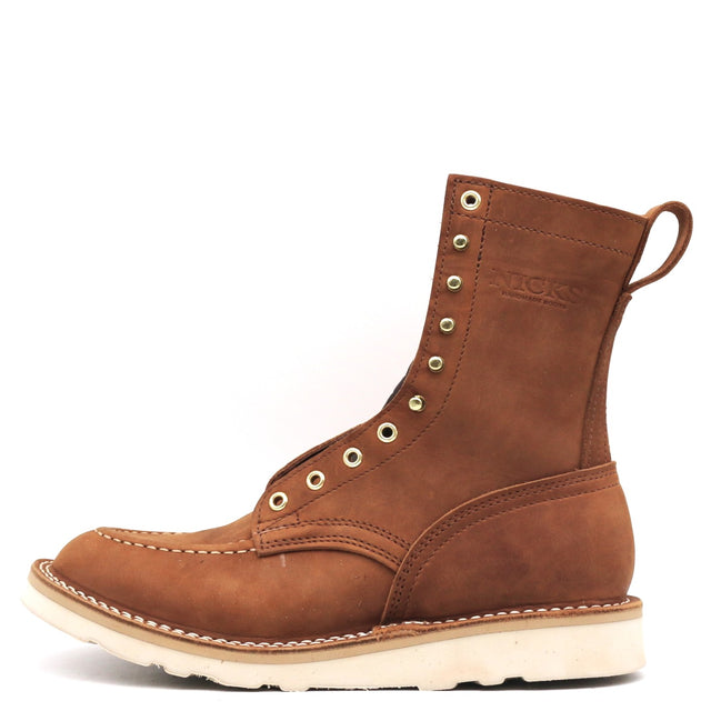 Brown eight inch tall boot with a moccasin toe and a white wedge outsole.