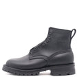 A black leather lace-up ankle boot with a thick lug sole, shown from a side profile on a white background. The brand name 'NICKS' is embossed on the side of the ankle collar.