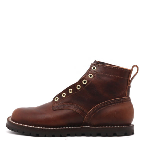 A brown leather lace-up ankle boot with gold-tone metal eyelets, contrast stitching, and a black lug sole, shown from a side profile on a white background.