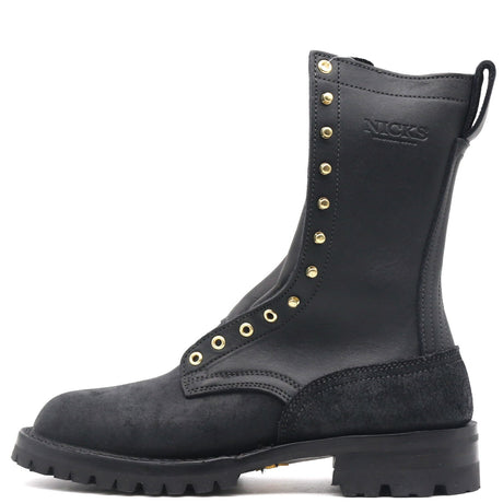 A black leather and suede lace-up boot with gold-tone metal eyelets and studs, featuring the embossed brand name 'NICKS' on the side, shown against a plain white background.