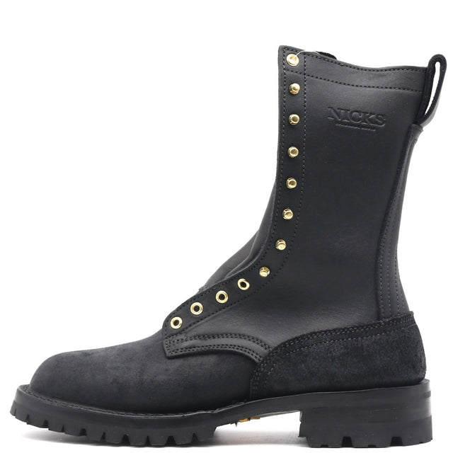 A black leather and suede lace-up boot with gold-tone metal eyelets and studs, featuring the embossed brand name 'NICKS' on the side, shown against a plain white background.