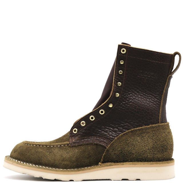 A single lace-up ankle boot in dark brown pebbled leather and olive green suede, featuring brass eyelets and a thick off-white sole, shown against a plain white background.