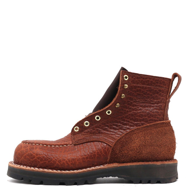 A single brown leather lace-up boot with a textured grain upper, suede side panels, brass eyelets, and a black rubber sole, shown against a plain white background.