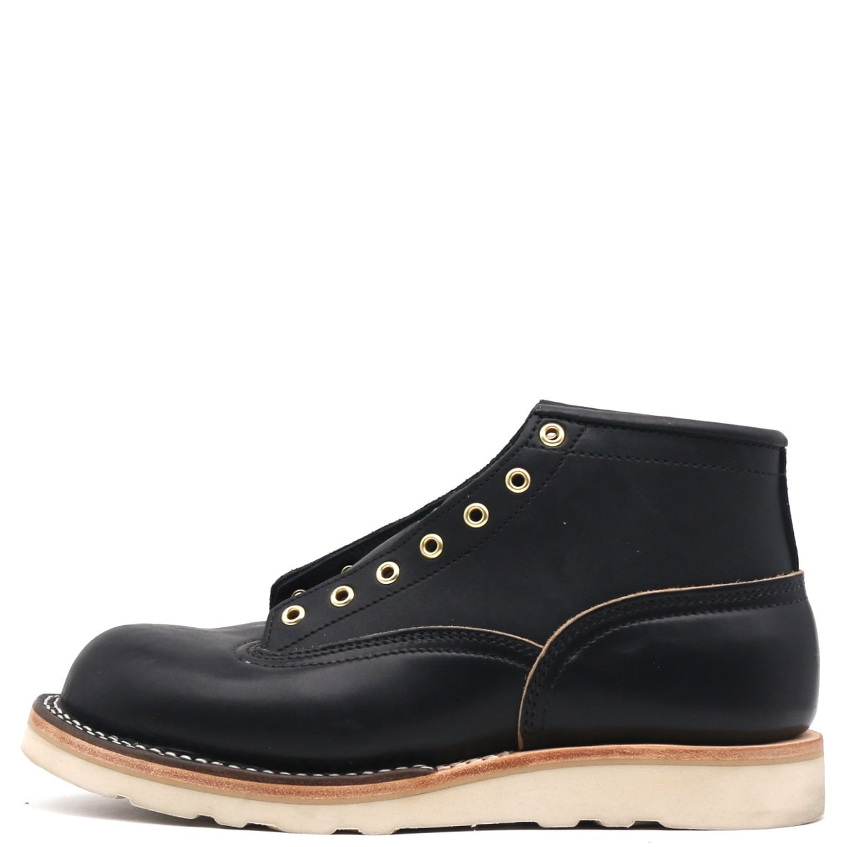 A single black leather high-top work boot with gold-tone metal eyelets, contrast stitching, and a thick off-white sole, shown from a side profile on a white background.
