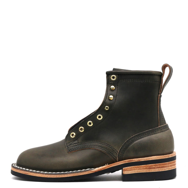 A dark olive green leather lace-up ankle boot with brass eyelets, a pull tab, and a stacked wood-and-leather sole, shown from a side profile on a white background.