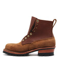 A brown leather lace-up work boot with a tan suede toe and heel, set against a plain white background.