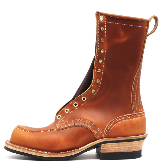 A single mid-calf brown leather boot with gold-toned metal eyelets and studs, a pull loop, and a stacked wood-look heel, shown on a plain white background.