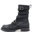 A black suede ankle boot with multiple strap buckles and a pull loop, shown from the side on a white background.