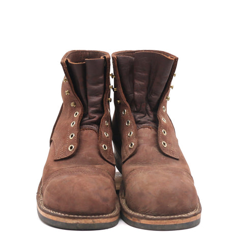 A pair of brown leather lace-up ankle boots with brass eyelets and pull tabs, shown from the front on a white background.