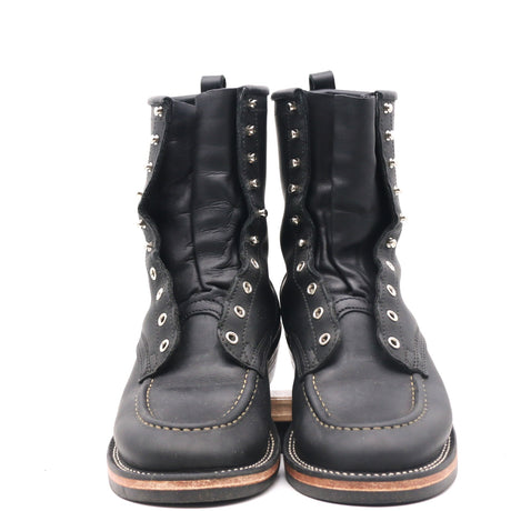 A pair of black leather lace-up ankle boots with silver metal studs and eyelets, shown from the front on a white background.
