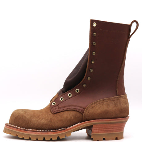 A mid-calf lace-up boot in brown suede and dark brown leather, featuring brass eyelets, a stacked lug sole, and a pull tab, shown against a plain white background.