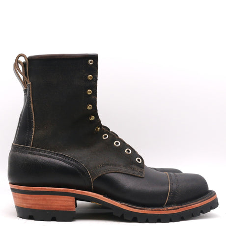 A single black leather lace-up work boot with brass eyelets and a stacked wooden heel, shown from a side profile on a white background.