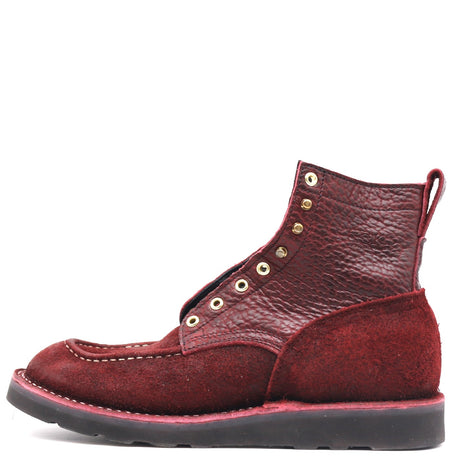 A single mid-calf lace-up boot in textured burgundy leather with gold-tone eyelets and a black sole, shown from a side profile on a white background.
