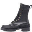 A black leather and suede mid-calf boot with gold-tone metal eyelets and studs, featuring a pull tab and a rugged sole, shown against a plain white background.