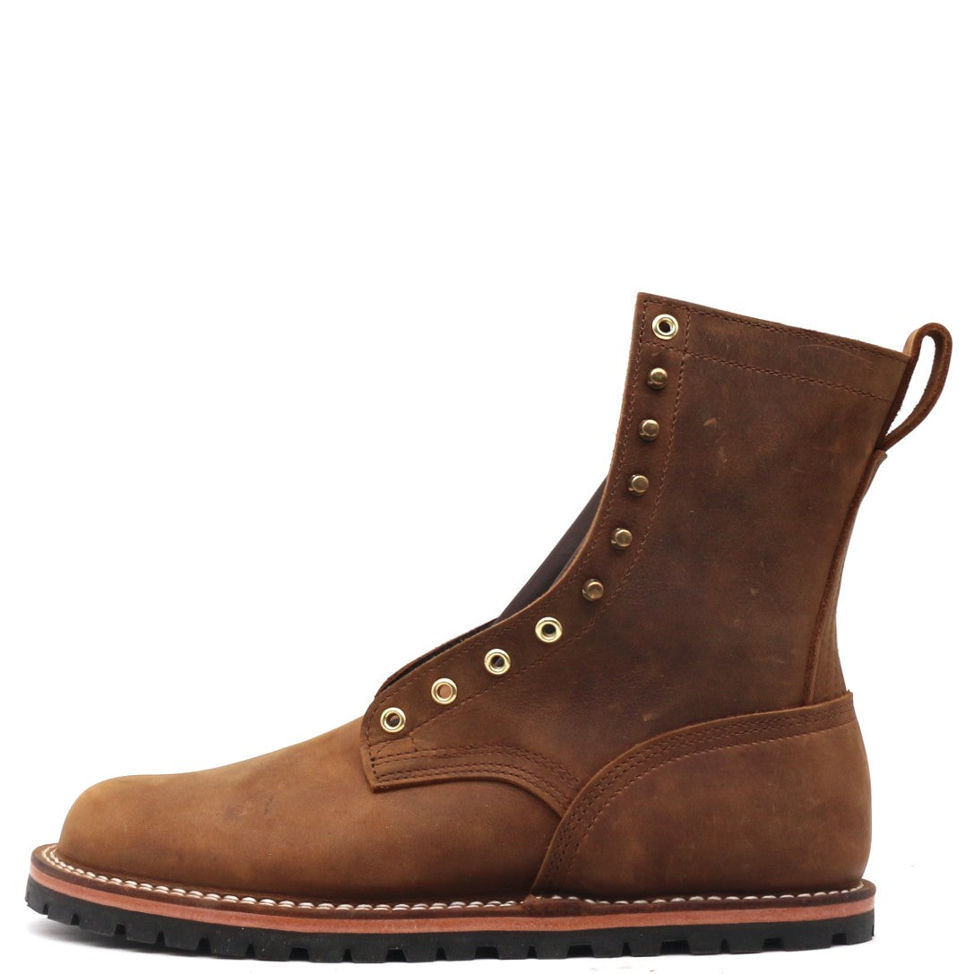 A brown suede ankle boot with brass eyelets, a pull tab, and a black rubber sole, shown from a side profile on a white background.