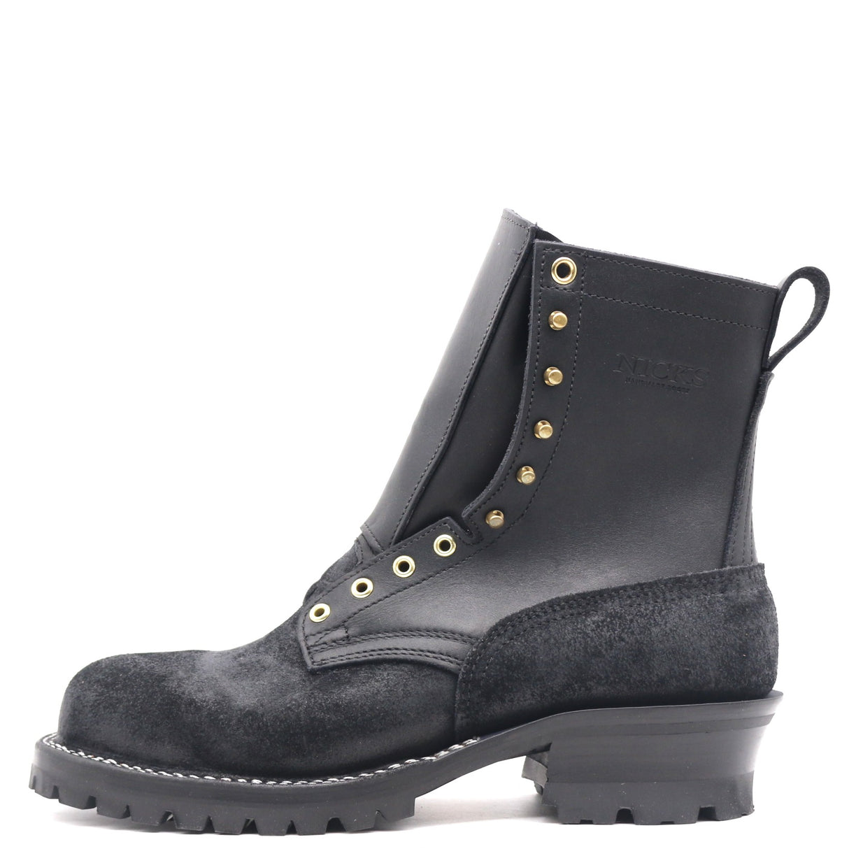 A black leather and suede lace-up ankle boot with gold-tone metal eyelets and studs, a pull tab, and a chunky lug sole, shown from a side profile on a white background.