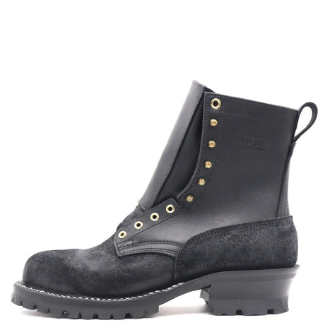 A black leather and suede lace-up ankle boot with gold-tone metal eyelets and studs, a pull tab, and a chunky lug sole, shown from a side profile on a white background.