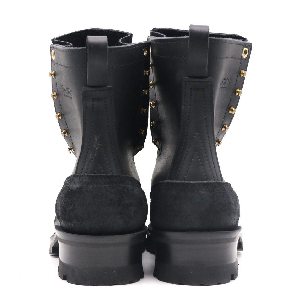 A pair of black leather and suede ankle boots with gold-tone metal studs, shown from the back against a white background.