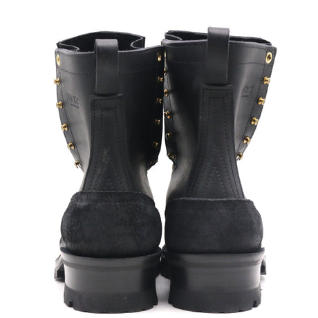 A pair of black leather and suede ankle boots with gold-tone metal studs, shown from the back against a white background.