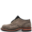 A single men's lace-up shoe in textured brown suede, featuring brass-tone eyelets, a black collar, and a stacked sole with a brown midsole and black outsole.