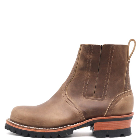A brown leather Chelsea boot with a chunky black lug sole, a light brown stacked midsole, and a pull loop on the heel, shown from a side profile against a white background.