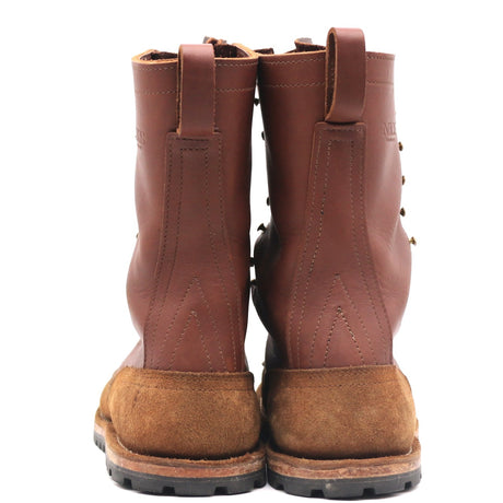 A pair of brown leather lace-up boots with thick brown suede-like soles, shown from the back against a plain white background.