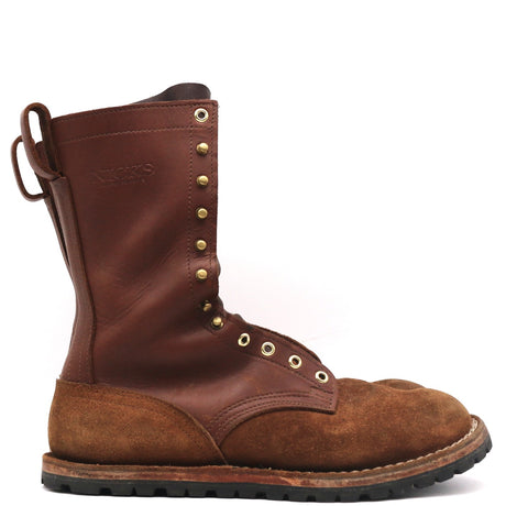 A brown leather lace-up work boot with a suede toe cap, brass eyelets, and a pull loop on the heel, shown from a side profile against a white background.