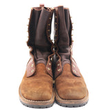 A pair of mid-calf brown suede boots with dark brown leather shafts, brass-tone metal studs, and decorative eyelets, shown against a plain white background.
